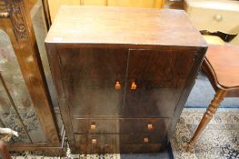 A 1930's walnut linen cabinet