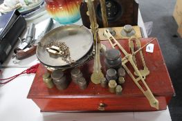 Two part sets of mahogany and brass scales together with a quantity of brass weights