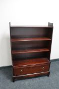 A Stag bookcase fitted with a drawer