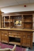 An Edwardian carved oak mirrored sideboard
