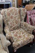 A reproduction armchair in floral covering
