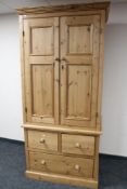 A pine double door wardrobe with three drawer chest in base, width 100 cm,