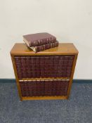 A small wooden bookshelf with encyclopedia Britannica