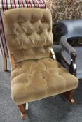 An upholstered brown dralon rocking chair