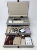 A jewellery box containing costume jewellery,