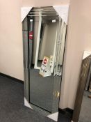 A contemporary all glass mirror 61 cm x 151 cm