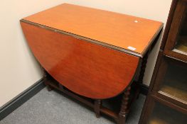 An oak gateleg table and two chairs