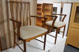 A pair of teak armchairs