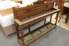 An Edwardian carved oak stick / umbrella stand,