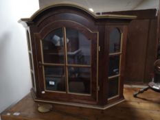 A decorative gilt highlighted wall cabinet