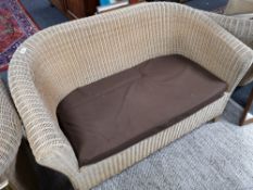 A three piece conservatory cane suite with matching stool