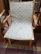 A beech armchair with fabric seat.