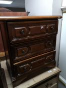 A reproduction three drawer chest