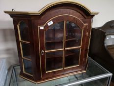A decorative gilt highlighted wall cabinet