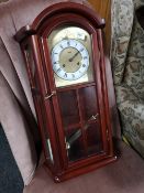 A contemporary wall clock with pendulum