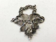 An early Victorian cast silver decanter label,