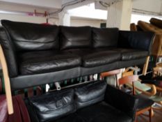 A Scandinavian black leather two seater and three seater settees.