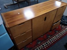A multi drawer double door teak sideboard