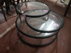 A mid century three tier adjustable coffee table.