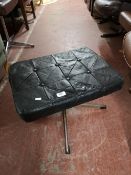 A mid century black studded leather swivel footstool.