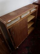 A mid 20th century teak shutter door cabinet.