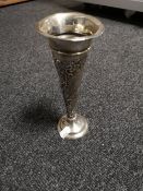 A slender silver spill vase