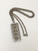 A silver ingot pendant on chain