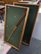 A table topped billiards game with two cues