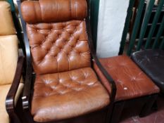 A Scandinavian armchair in dark studded tan leather and footstool.