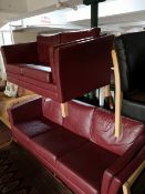 A Scandinavian Burgundy leather two seater and three seater settees.