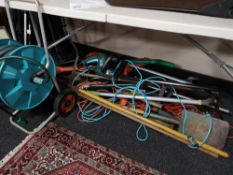 A quantity of garden tools, hedge cutter, electric strimmer,