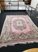 A pink fringed Chinese carpet,