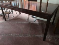 A contemporary mahogany coffee table.