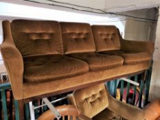 A mid century mustard coloured three seater settee.