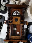 An Edwardian stained beech wood wall clock
