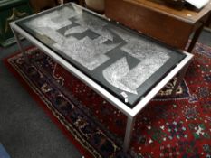 A contemporary glass topped coffee table