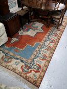 A fringed Eastern carpet,