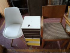 A light oak chair, an office multi drawer chest and a white chair.