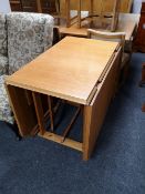 A mid century beech flap sided table