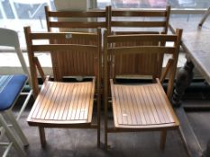 Four folding beech chairs.