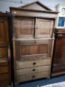 A nineteenth century oak secretaire cabinet