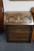 An oak linen fold bureau