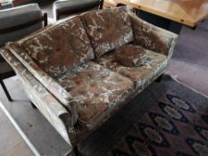 A contemporary two seater settee in floral fabric,