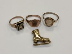 Three 9ct gold rings and a 9ct gold ice skate charm CONDITION REPORT: 10.3g gross.