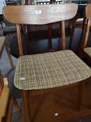A set of mid century teak dining room chairs.