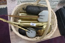 A wicker basket containing clock weights and pendulums