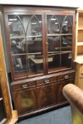 A mahogany double door bookcase fitted with three cupboards
