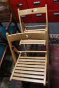 A set of four folding beech chairs