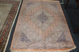 A fringed eastern rug on peach ground,