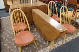 An Ercol elm flap sided table and four chairs